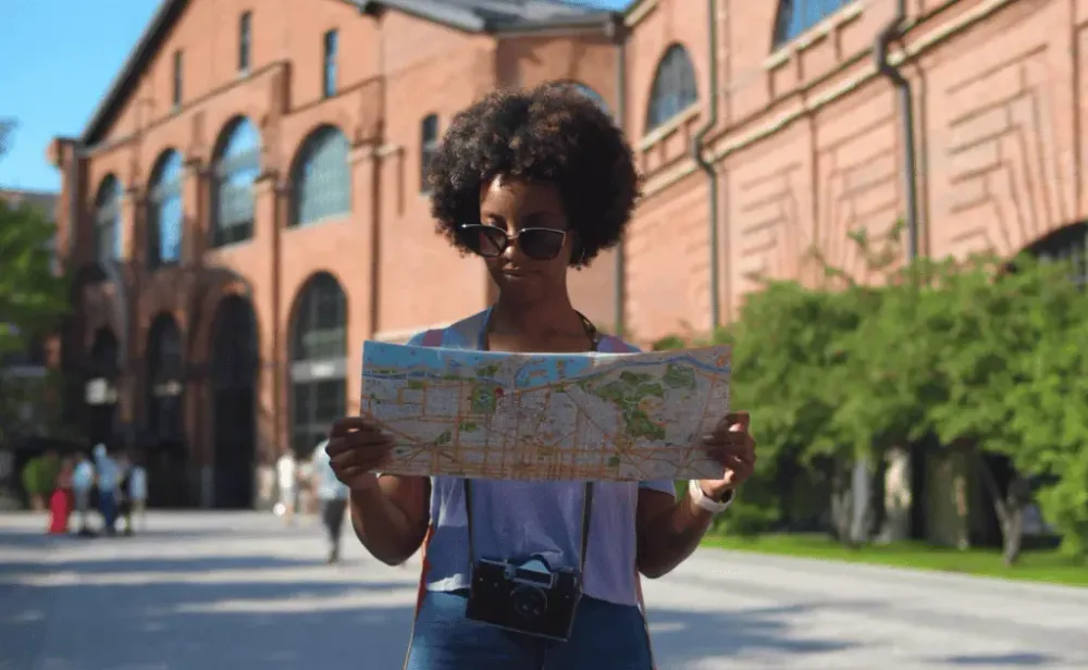 Woman looking at map traveling abroad